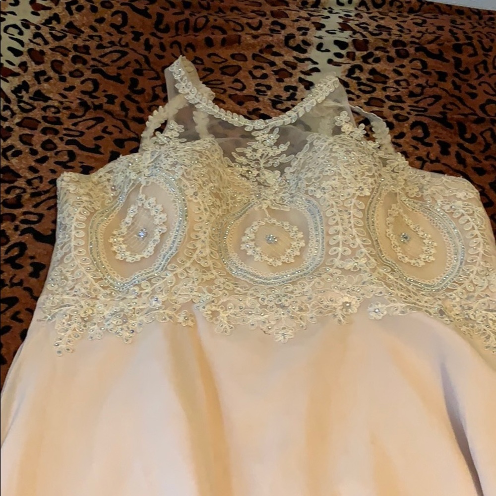 Cream colored dress with blue rhinestones.